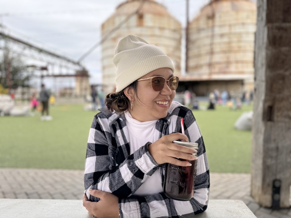 Dannette outdoors with a coffee